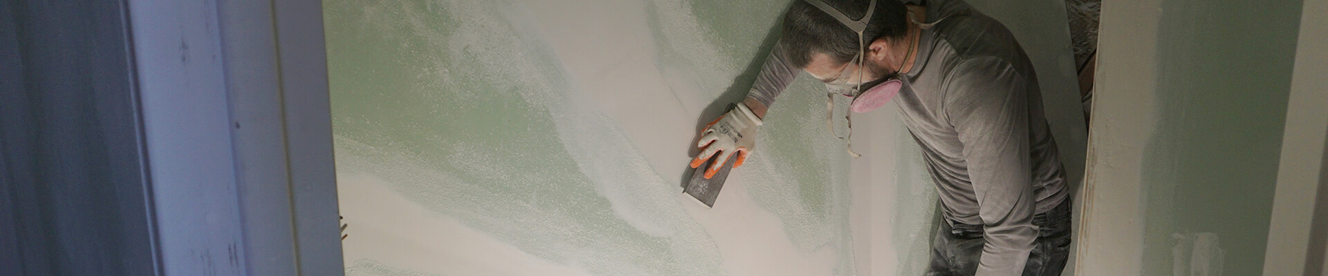 A close-up view of the drywall being finished in the Mini Dome.