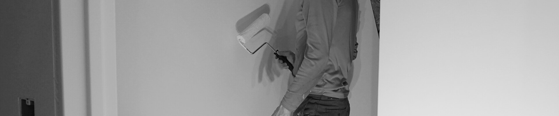 A close-up view of painting the Mini Dome interior walls in black and white.