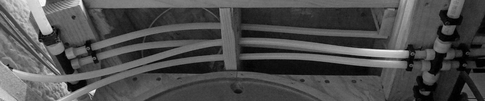 A close-up view of the plumbing in the Mini Dome in black and white.